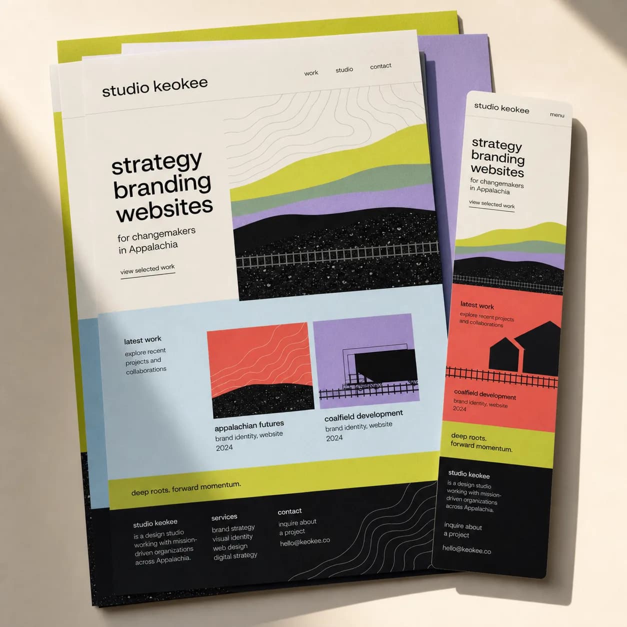 Printed website layouts and a phone screen showing a studio keokee site design